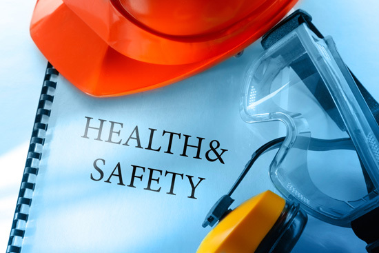 Health and Safety book with protective glasses and hardhat